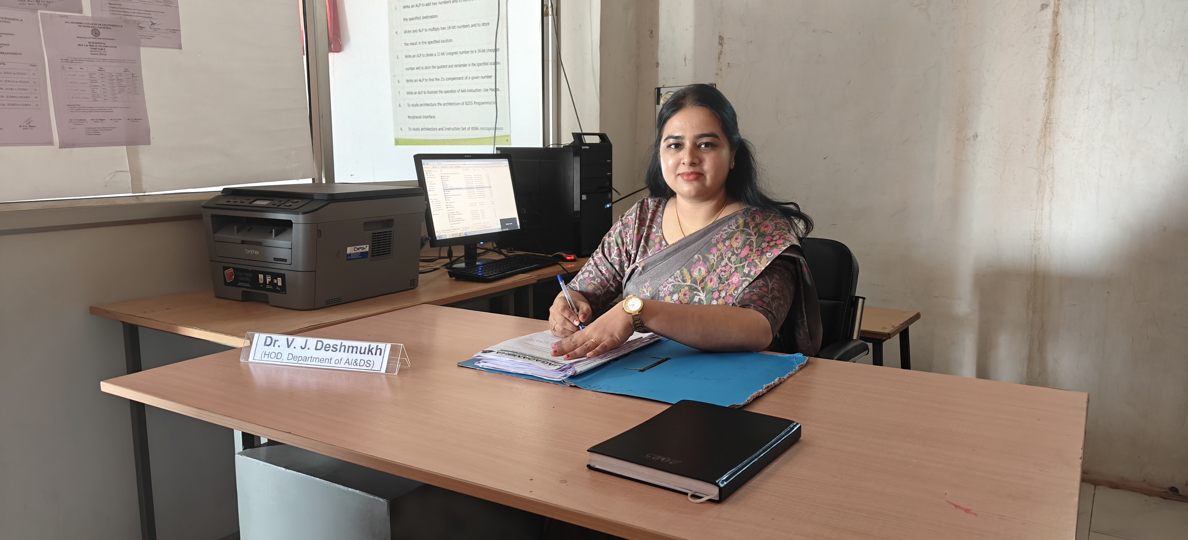 Portrait Of Smiling Male College Student In Busy Communal Campus Building